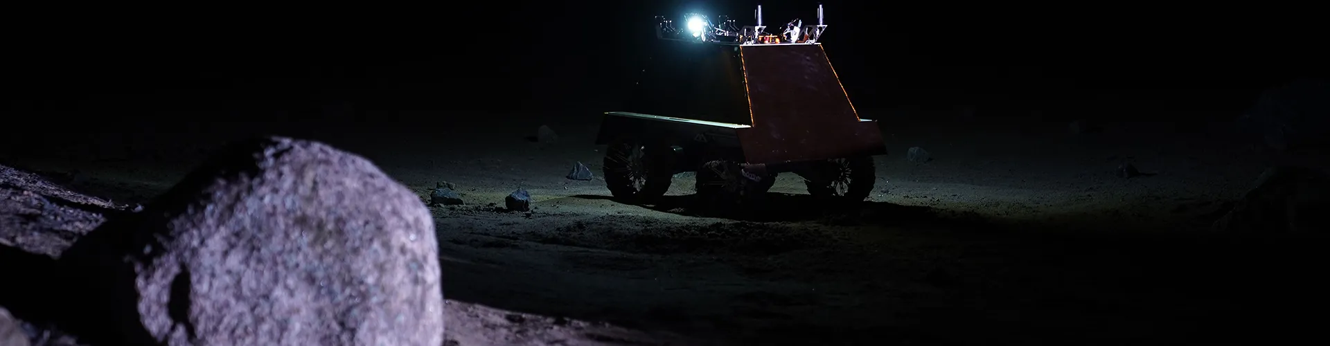 A lunar rover on the moon in shadow